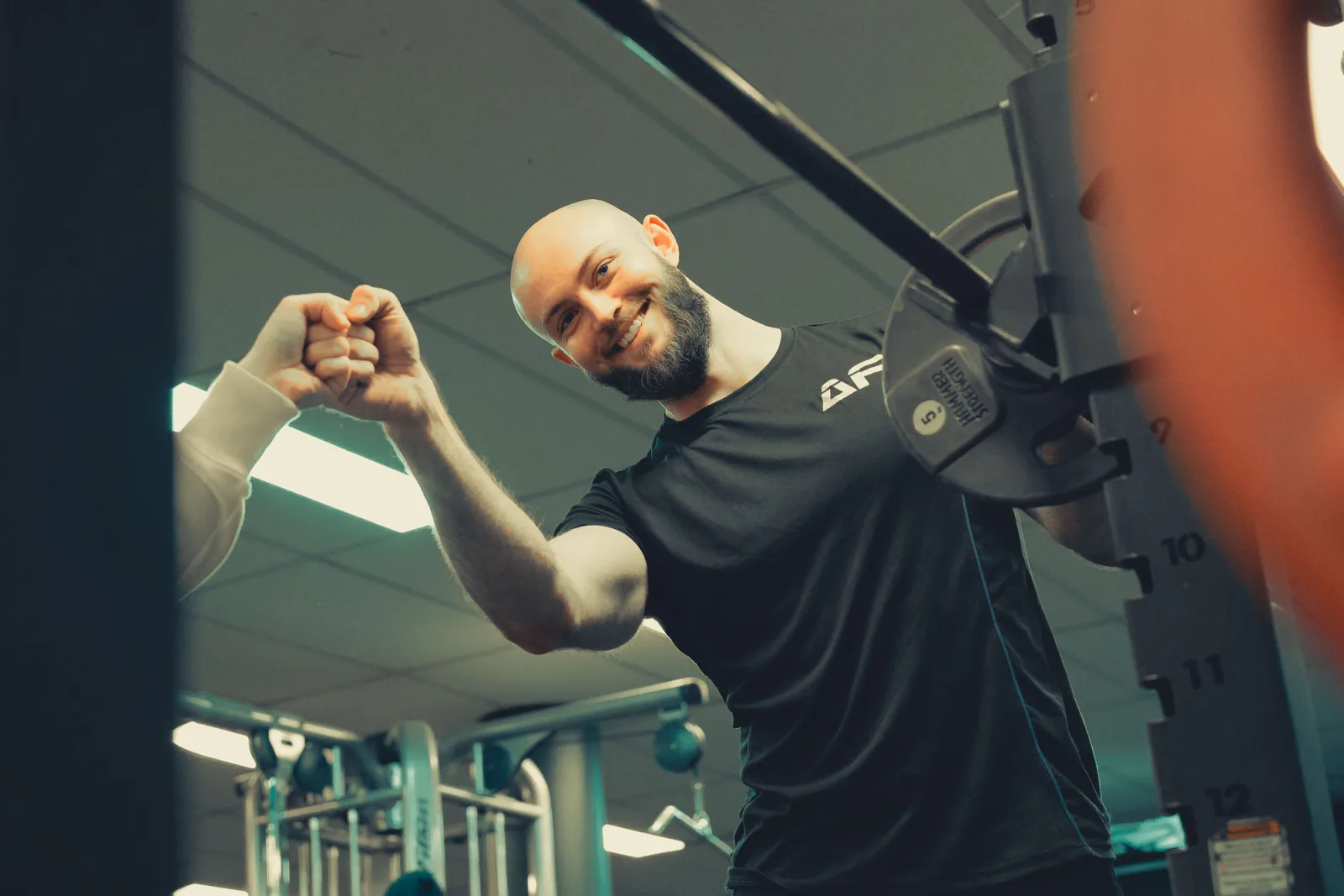 Edwin Henrich sharing a fist bump with a client after a session